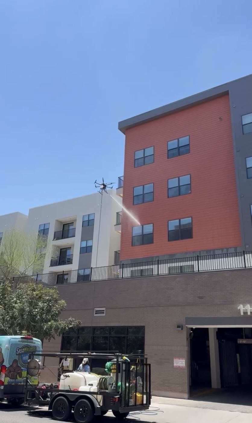 SasqWashers drone washing a multi-story building